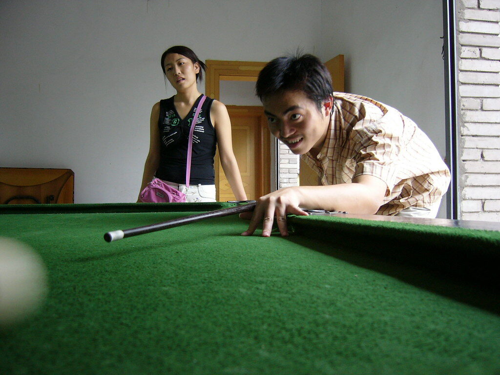Students playing pool in common room